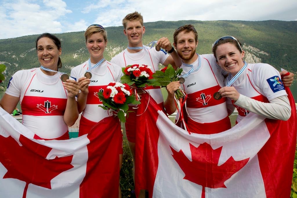 Image of Victoria and team holding a Canada flag