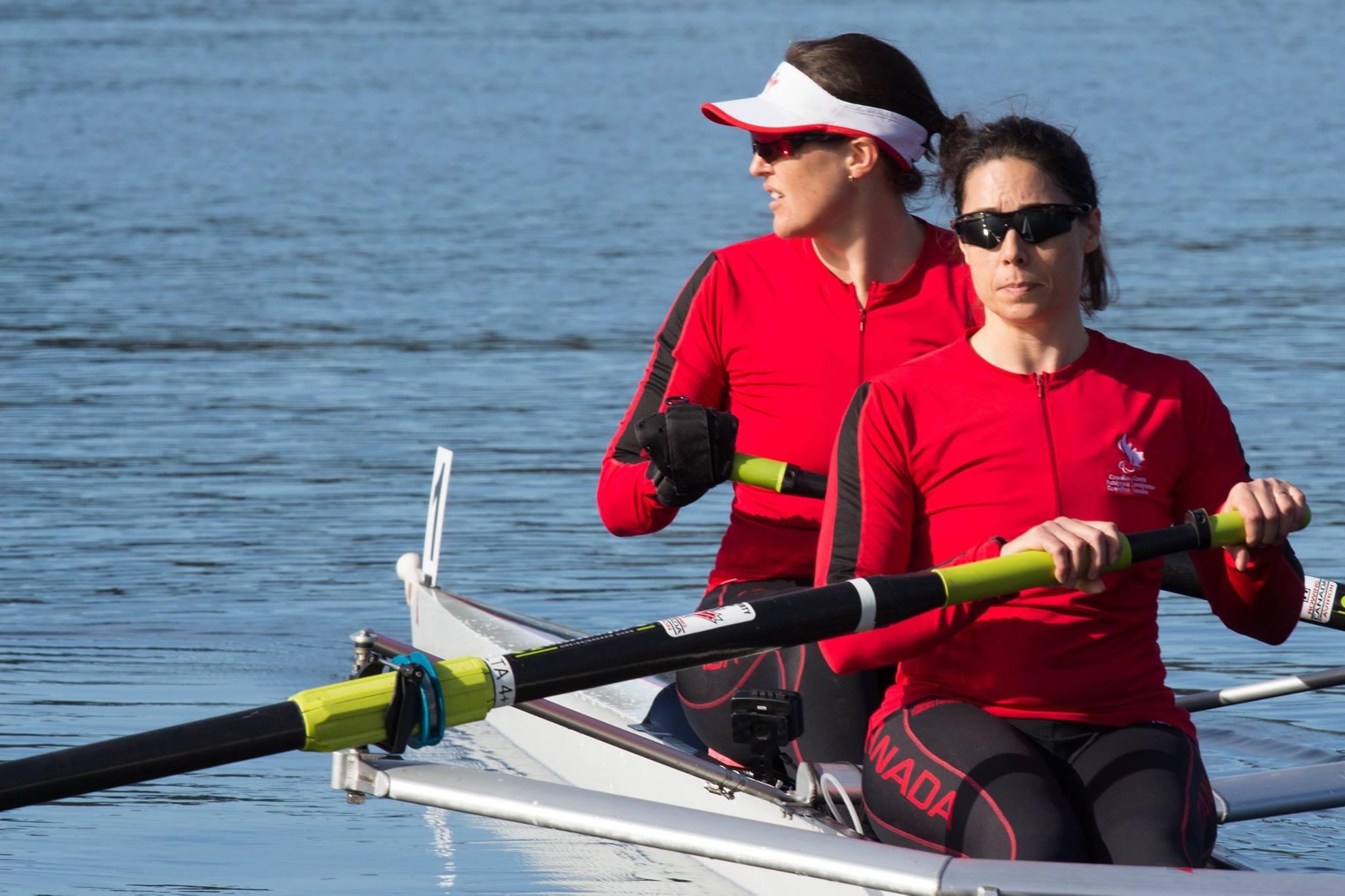 Image of Victoria and a team member in a rowboat on the water