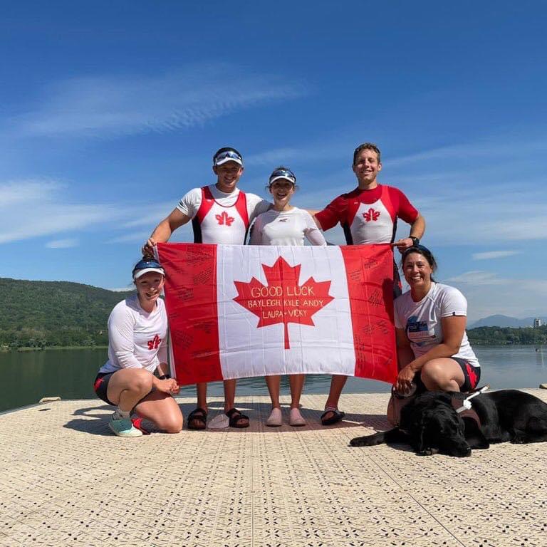 Image of Victoria and team holding a Canada flag