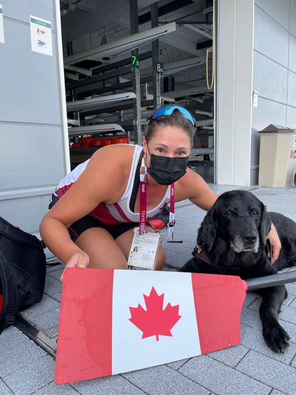 Victoria and seeing eye dog kneeling down with a canada flag