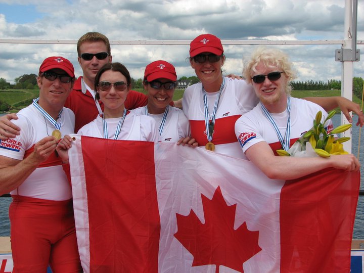 Image of Victoria and team holding a Canada flag